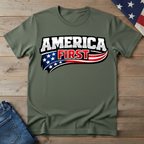 Green t-shirt with 'America First' graphic on a wooden surface