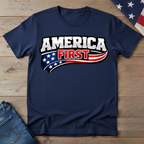 Navy blue t-shirt with 'America First' graphic on a wooden surface