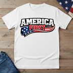 White t-shirt with 'America First' graphic on a wooden surface